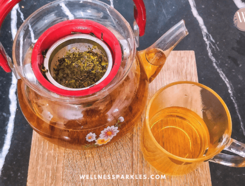 tea pot with oregano and olive tree leaves tea and a cup